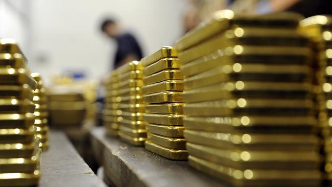 Gold ingots are stacked at a gold producing and refining plant in Mendrisio, Switzerland. (Photographer: Adrian Moser/Bloomberg)