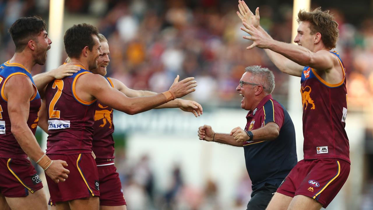 Brisbane coach Chris Fagan celebrates with players after a win this year.