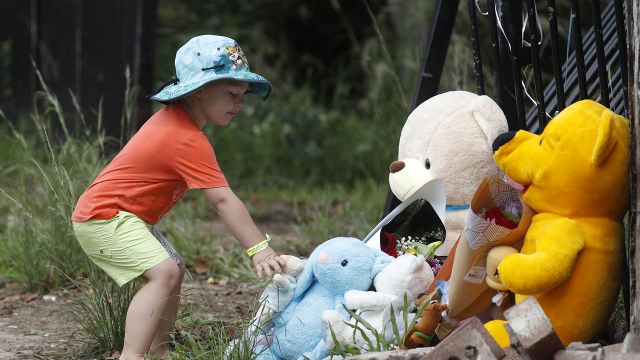 People leaving flowers at the scene on Warne St in Wellington. Picture: Jonathan Ng