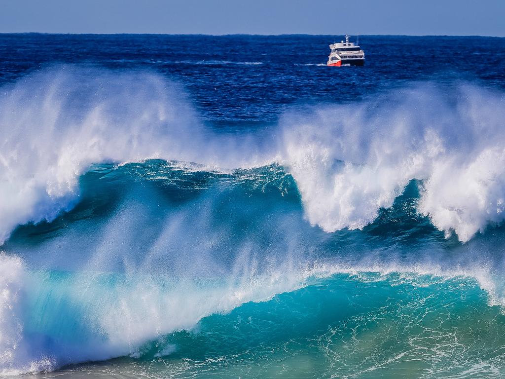 Sydney’s Bondi Beach is pictured coated with massive waves. Picture: Craig Greenhill