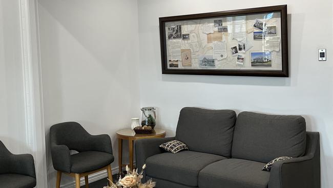 Inside the waiting room of Channon Lawrence Dental with the framed history and story of Nelroyd.