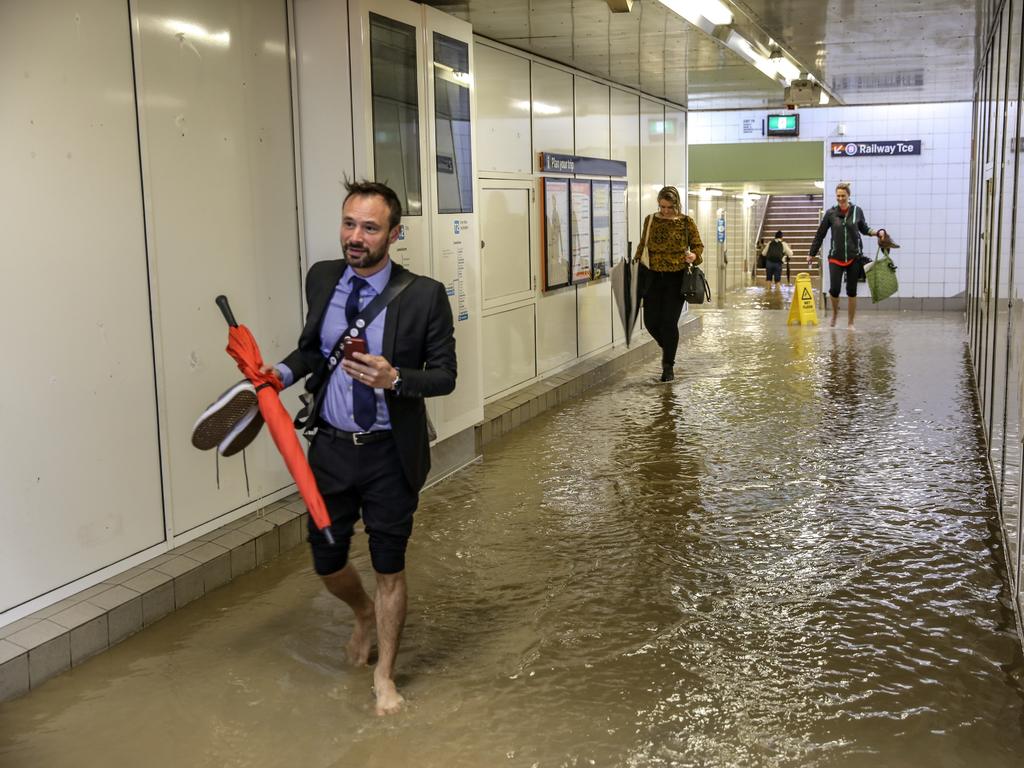 Shoes off at Lewisham station was the easiest option for this commuter. Picture: Nicholas Eagar