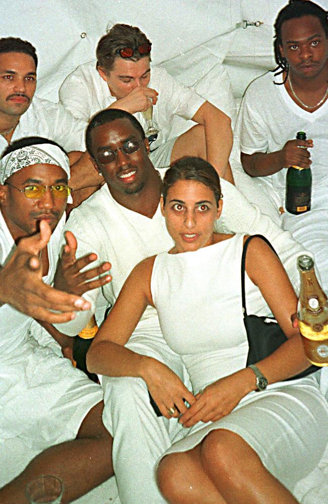 Then aged around 24, Dicaprio (back centre) gulps down his drink white lounging with Diddy’s friends on a bed. Picture: Globe Photos/Shutterstock