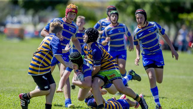 Day One of King of the Country rugby tournament at James Overell Park, Southport. possible. Sunshine Coast Invitational Barbarians U13s (Blue/yellow) v USQ Saints U13s (being tackled). Picture: Jerad Williams