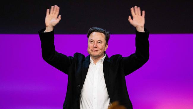 Tesla chief Elon Musk waving onstage at the TED2022, where he previewed his “Plan B” for taking Twitter private. Picture: AFP.