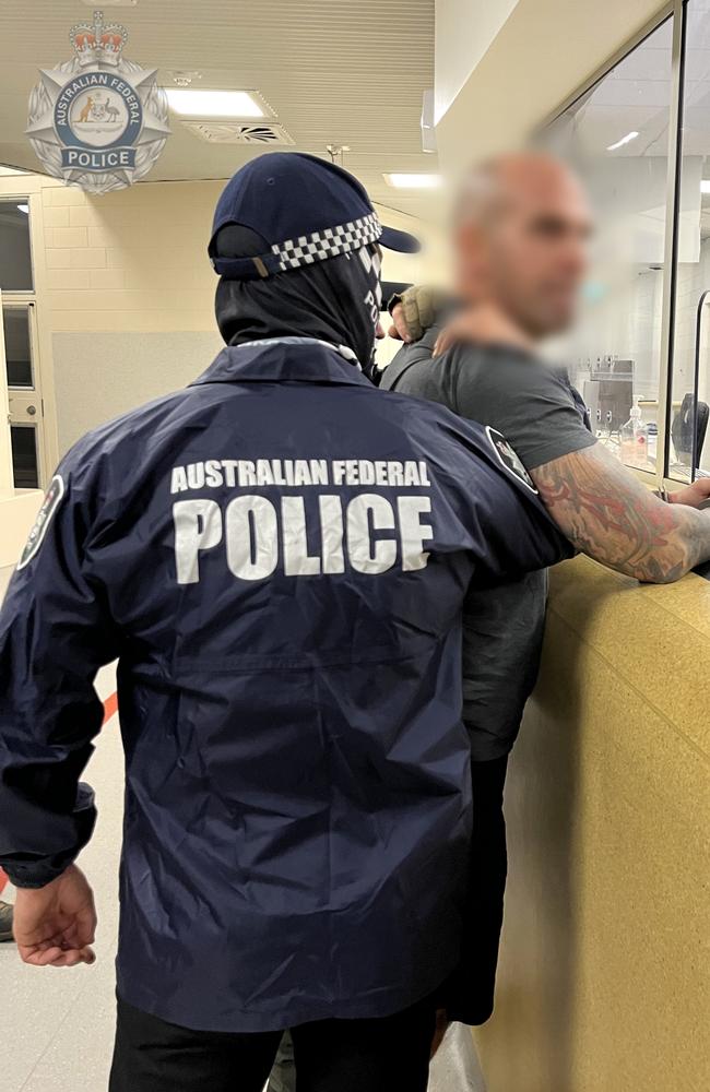 AFP offiers with Mark Buddle, arrested for allegedly importing more than 160kg of cocaine into Melbourne in May, 2021. Picture: Australian Federal Police