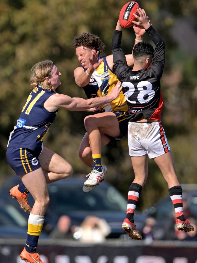 EFNL: Beaconsfield pair Benjamin Schultze and Joshua Mounter tangle with North Ringwood’s Robin Nahas. Picture: Andy Brownbill