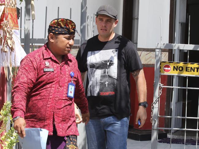 The Bali Nine’s Matthew Norman and his jailer walk out from his tower cell. Picture. Lukman S. Bintoro.