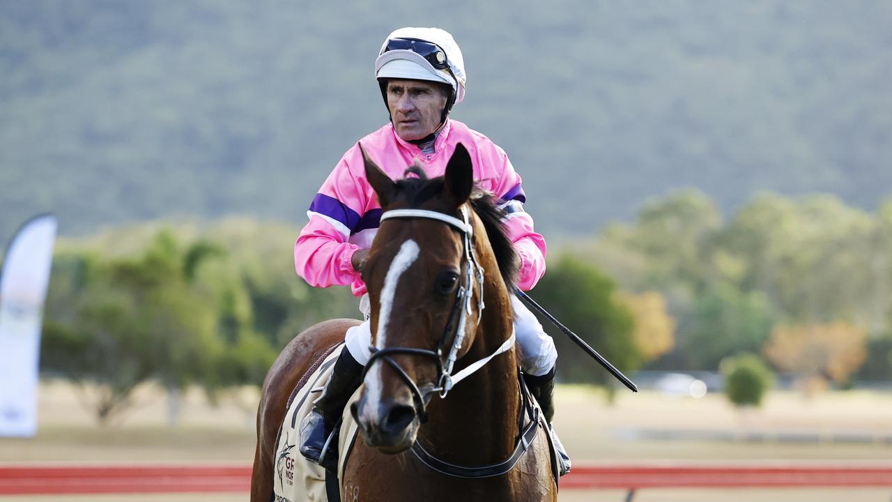 Fast Train, ridden by jockey Shane Pawsey, returns to scale after winning the Gordonvale Cup, held at the Gordonvale Turf Club. Picture: Brendan Radke