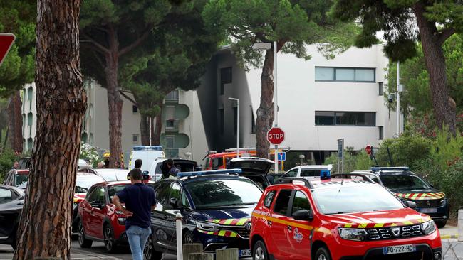 Law enforcement officers and firefighters stand in front of a burnt building nearby a synagogue following the fire and explosion of cars in La Grande-Motte, south of France. Picture: AFP