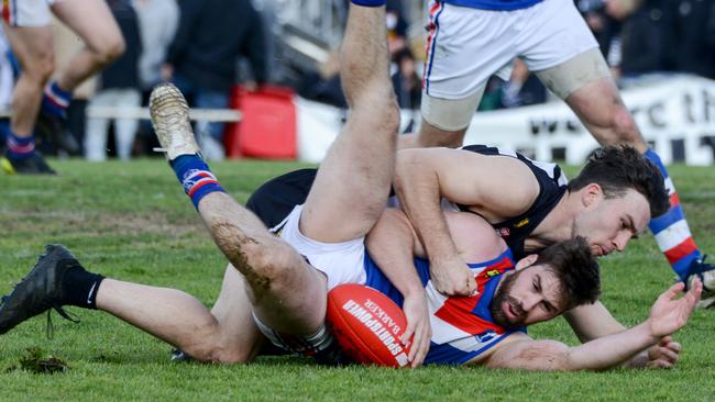 Onkaparinga Valley midfielder Tim Webber is crunched in a tackle Troy Parker-Boers from Hahndorf in last year’s HFL grand final. Picture: AAP/Brenton Edwards