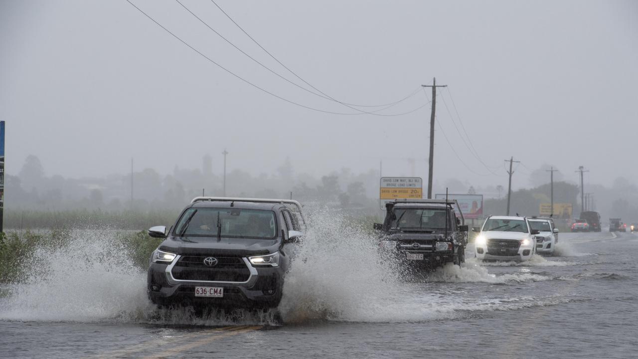 Motorists brave flood waters on the David Low Way near Bli Bli. Picture: Brad Fleet