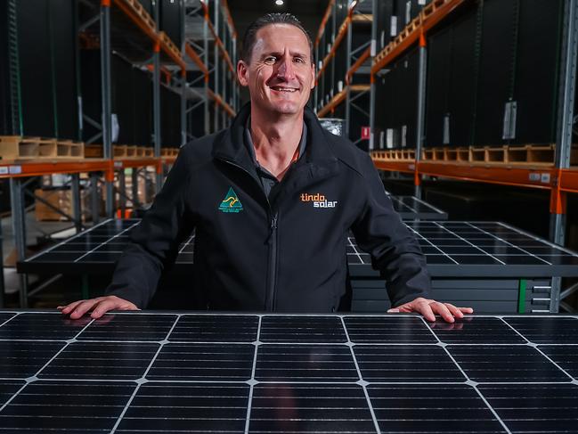 Tindo Solar chief executive Shayne Jaenisch with solar panels in the warehouse at their local manufacturing facility in Mawson Lakes, South Australia. Picture: Tom Huntley