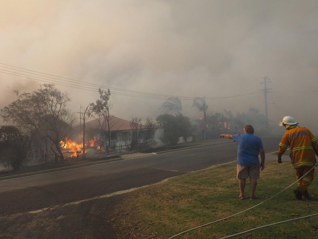 A bush fire rages in the town of Tathra on Sunday afternoon, March 18, 2018. Picture: John Ford