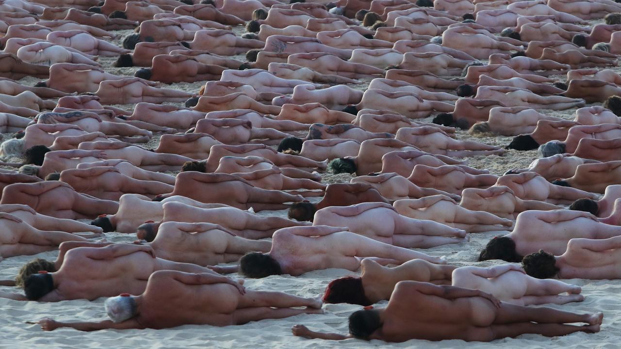 Tunick’s instruction that we all lay naked on the cold wet sand took some convincing. Picture: Lisa Maree Williams/Getty