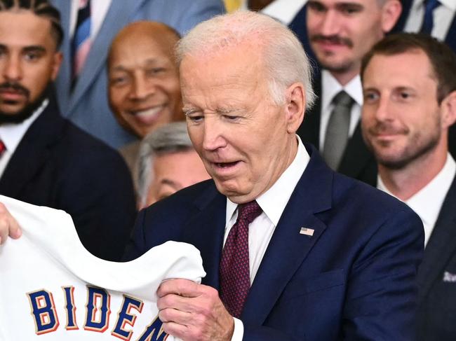 US President Joe Biden receives a Texas Rangers jersey from Rangers manager Bruce Bochy (L) during an event to celebrate the Texas Rangers' 2023 World Series championship in the East Room of the White House in Washington, DC, on August 8, 2024. (Photo by Mandel NGAN / AFP)