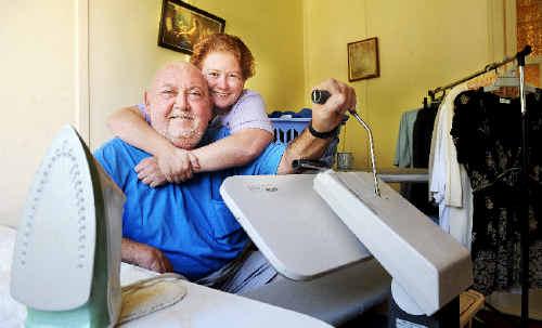 Lismore resident Barry Ford gets a hug from his wife, Lisa, as he willingly attends to the ironing. . Picture: Jacklyn Wagner