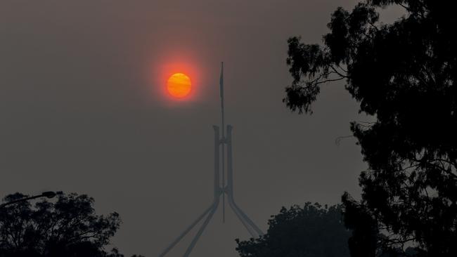 Parliament House today through the smoke haze from the NSW fires which has once again blanketed the nation's capital, Canberra. Picture Gary Ramage