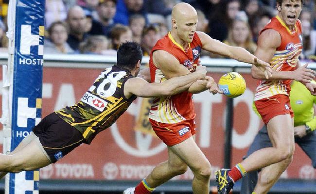 ACTION PACKED: Paul Puopolo of Hawthorn and Gary Ablett of The Gold Coast Suns in action during their Round 21 AFL game at the MCG in Melbourne. Picture: Aap