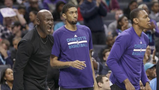 Charlotte Hornets owner Michael Jordan, left, shouts at an official during a game against the Washington Wizards. (AP Photo/Chuck Burton)