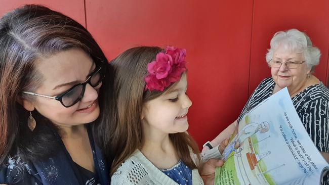 Author Jo Brookshaw, her daughter Hosanna, 6, and artist Betty Maher with the children’s book <i>Hope’s ANZAC Adventure</i>.