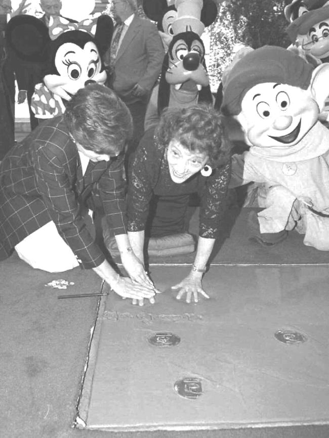 Adrianna Caselotti, original voice of Snow White in 1937 classic Disney animated film, places hand prints in cement at Walt Disney Studios.