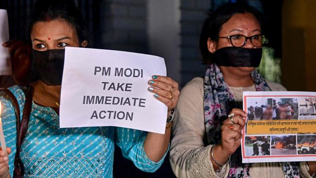 Members of the Satra Mukti Sangram Samiti (SMSS) hold placards during a protest over sexual violence against women and for peace in the ongoing ethnic violence in India's northeastern state of Manipur, in Guwahati on July 20, 2023. (Photo by Biju BORO / AFP)