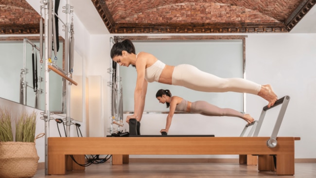 Before long, you’ll be smiling your way through your instructor’s wicked ab set. Image: Getty