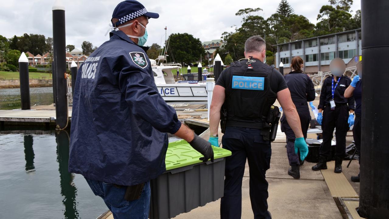 Police uncovered 11 plastic tubs full of cocaine on the smaller boat.
