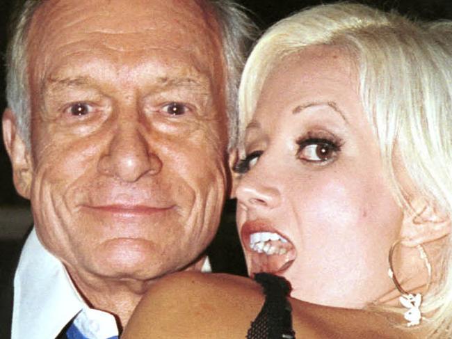 WEST HOLLYWOOD, CA - SEPTEMBER 24: Publisher Hugh Hefner and girlfriend Holly Madison flash outside The Standard Hotel on September 24, 2003. (Photo by David Klein/Getty Images)