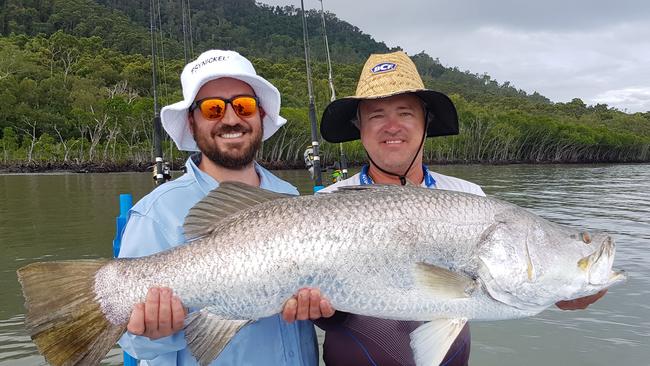 Shaun Muhlnickel (left) caught this 111cm barra while fishing with guide Ian Moody.