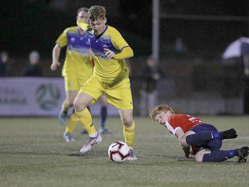 Lokoseljac Cup Final at KGV. Devonport Strikers versus South Hobart. Devonport's Max Fitzgerald takes on South Hobart's Adam Gorrie and shoots at goal. Picture: PATRICK GEE