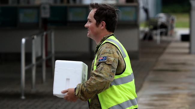 A test sample is taken to a waiting RAAF Hercules at Christmas Island airport on Monday. Picture: Colin Murty