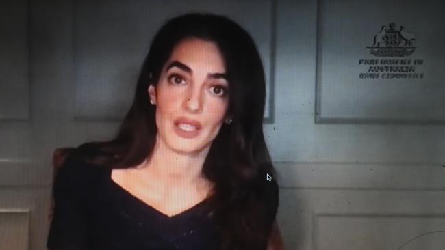 Human Rights lawyer Amal Clooney is seen on a screen as she gives evidence in front of a Senate Inquiry on the topic of the Magnitsky Act at Parliament House in Canberra. Picture: AAP