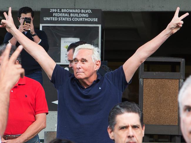 Roger Stone, a longtime adviser to US President Donald Trump, throws up peace signs outside court earlier this year. Picture: Joshua Prezant