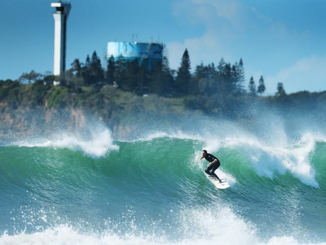 A surfer takes on a wave at Alexandra Headland on the Sunshine Coast. Picture: Lachie Millard