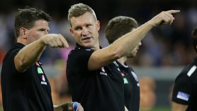 Nathan Buckley talks to Robert Harvey at the Gabba. Picture: Peter Wallis