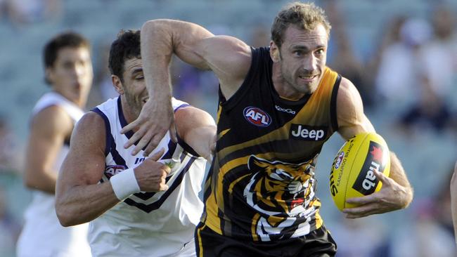 AFL NAB CUP - Fremantle Dockers v Richmond Tigers at Patersons Stadium, Perth. PICTURED- Richmond's Shane Tuck shrugs the tackle from Docker Ryan Crowley.