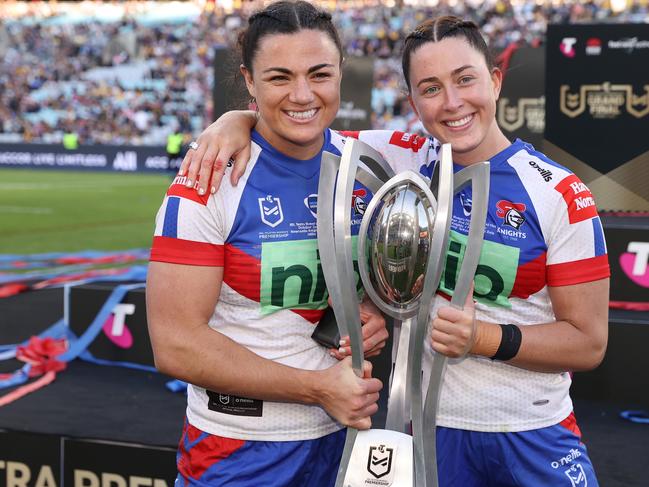 SYDNEY, AUSTRALIA - OCTOBER 02: Millie Boyle and Romy Teitzel of the Knights hold the NRLW Premiership Trophy after victory in the 2022 NRLW Grand Final match between Newcastle Knights and Parramatta Eels at Accor Stadium, on October 02, 2022, in Sydney, Australia. (Photo by Cameron Spencer/Getty Images)