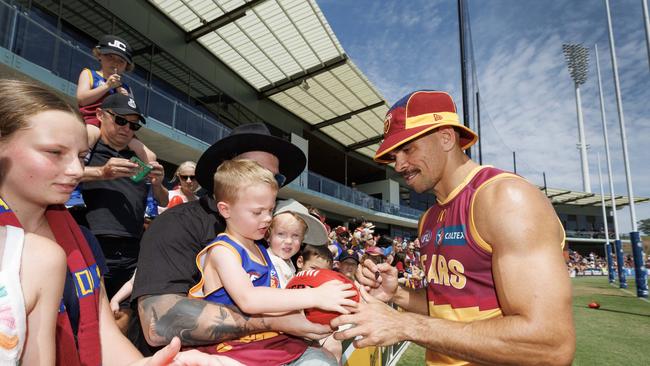 Charlie Cameron signs a footy for 5-year-old Hunter Ward. Picture: Lachie Millard.