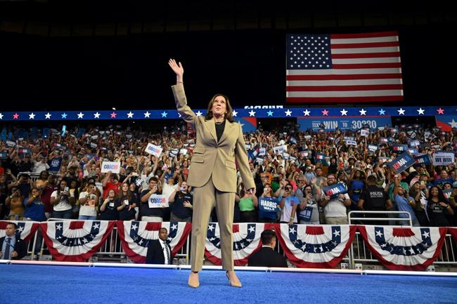 US Vice President and 2024 Democratic presidential candidate Kamala Harris waves on stage during a campaign event at Desert Diamond Arena in Glendale, Arizona, on August 9, 2024.