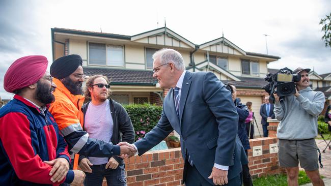 Prime Minister Scott Morrison shakes hands with a passer-by in Jamisontown to meet first home buyers. Picture: NCA NewsWire / Christian Gilles