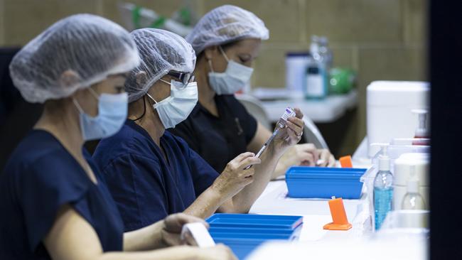 PERTH, AUSTRALIA - APRIL 28: Nurses are seen drawing up doses from a multi-dose vile of AstraZeneca Covid-19 vaccine at Claremont Showground on April 28, 2021 in Perth, Australia. The West Australian Government have opened up two new Vaccine Centres including one at Perth Airport. (Photo by Matt Jelonek/Getty Images)