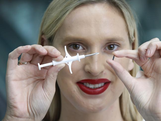 Startup entrepreneur Gretta Van Riel holds the syringe and the microchip implant that went under the skin of her wrist, at Pause Fest 2018. Picture: David Caird