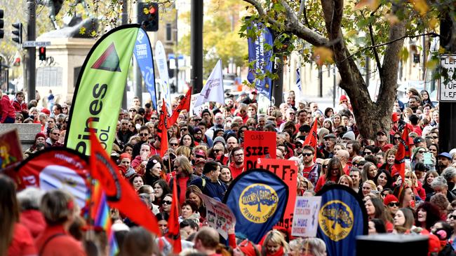 Protesters hold placards during the teachers’ strike on Monday. (AAP Image/Sam Wundke)