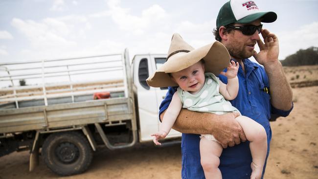 Scott Mudford, pictured with his 11-month-old daughter Fearne, helps run his family sheep and grain farm north west of Dubbo. Picture: Dylan Robinson