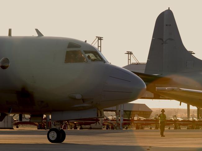 Ground crew guide in an RAAF AP-3C Orion at RAAF Pearce in Perth, Western Australia, Tuesday, April 8, 2014. The aircraft completed a search mission for missing Malaysia Airways Flight MH370. (AAP Image/Richard Wainwright) NO ARCHIVING