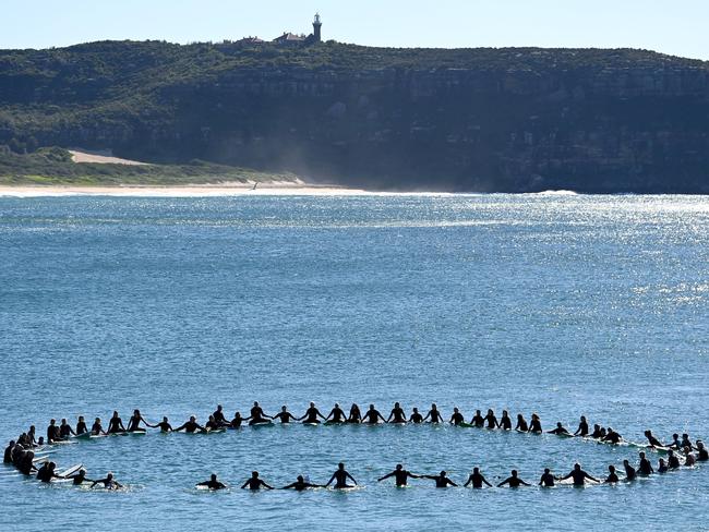 The friends and family of fatal shark attack victim Mark Sanguinetti hold a 'paddle out' in the surf at Palm Beach in honour of the surfer's who was killed by a shark in Tuncurry last week. Picture: NCA NewsWire / Jeremy Piper