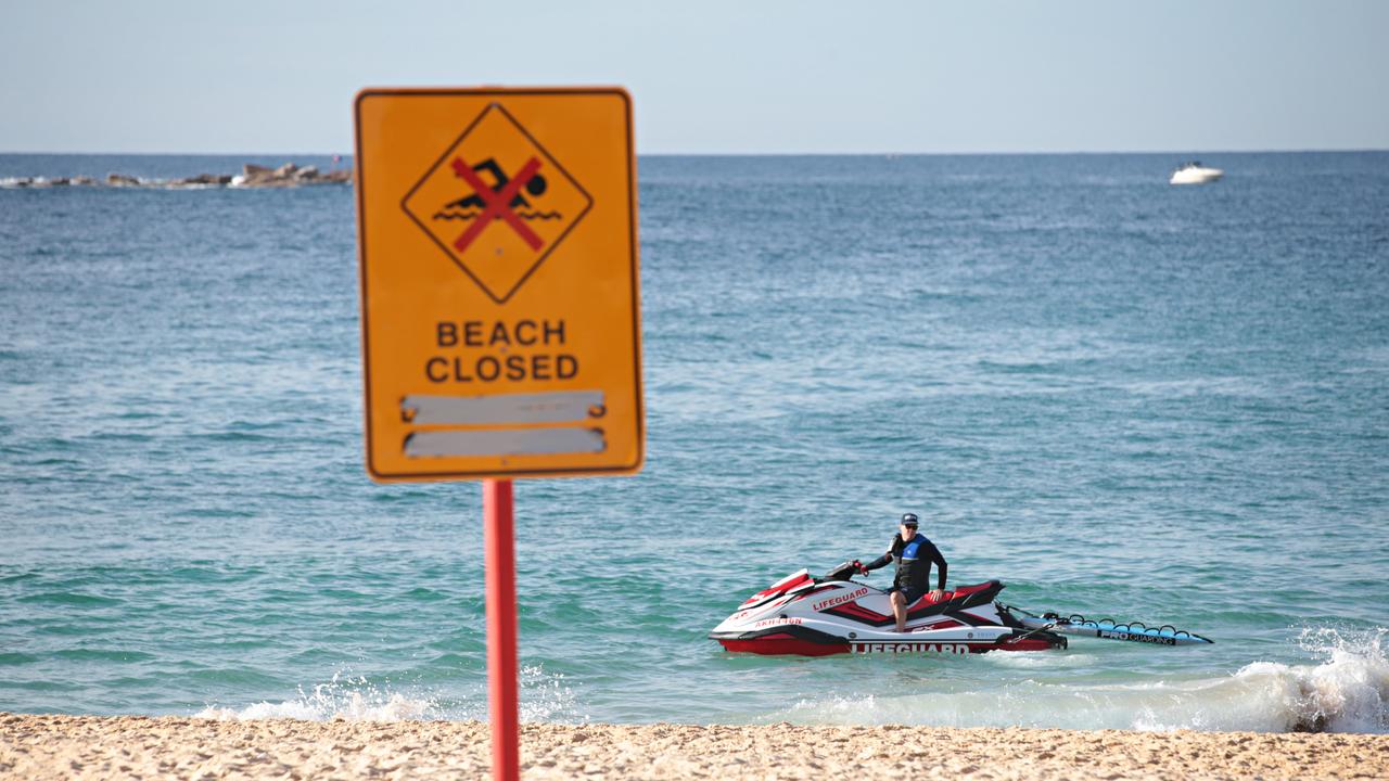 Lifeguards on jet skies telling people to get out of the water after 9am at Coogee beach on April 26. Picture: Adam Yip