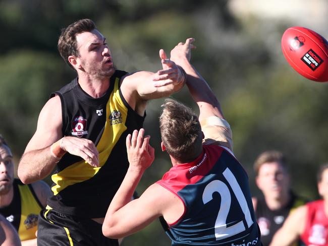 Round 2 of the QAFL Australian rules competition between Labrador and Surfers Paradise. Matthew Green ( 21 ) of Surfers Paradise clashes with Labrador's Fraser Thurlow ( left ) . Photograph : Jason O'Brien